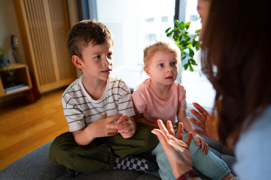 Mother correcting children during conversation