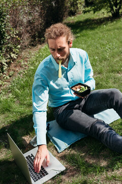 Working Outdoors While Enjoying a Fresh Meal During Sunny Afternoon