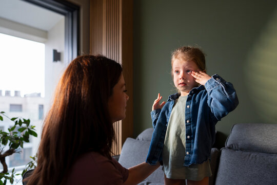 Child getting dressed with parent help at home