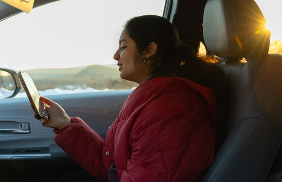 Girl smiling and singing on a sunset drive