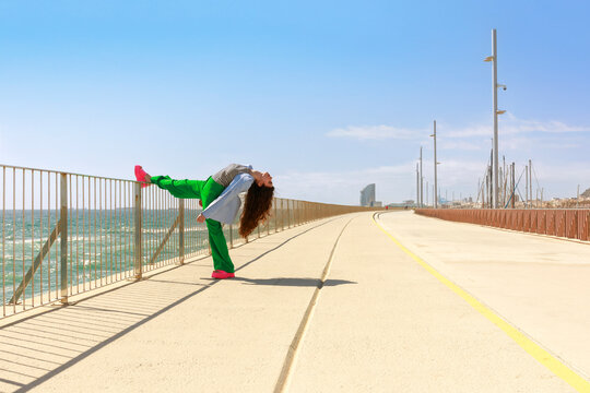 Woman Doing a Dance Pose  Near the Ocean 