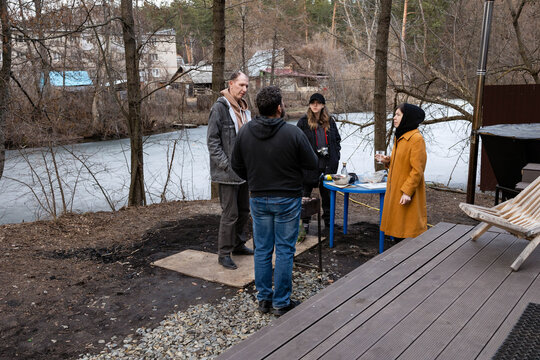 People stand by the river and talk.