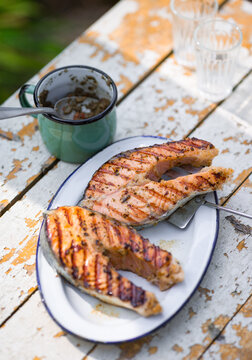 Freshly grilled salmon served on a rustic table outdoors