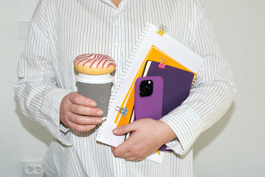 Person with coffee and notebooks