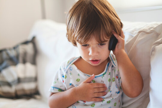 Young child imitating conversation using a mobile phone