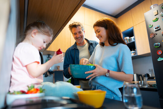 Family cooking together in a modern kitchen space
