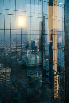 Abu Dhabi skyline reflected in glass skyscraper facade