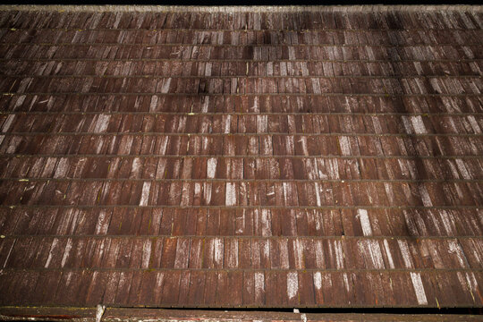Wooden bricks as roofing on a wooden hut