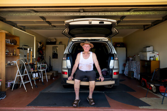 Elderly man sitting in garage at home in rural New South Wales