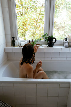 A woman is taking a bath 