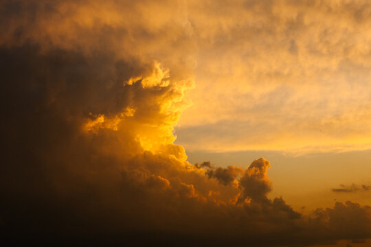Dramatic storm clouds glowing at sunset