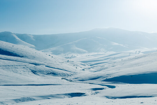 Snow covered mountain valley in winter light