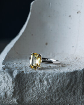 Luxury Yellow Gem Ring on Concrete Fragment Macro