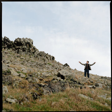 Hiker standing on rocky slope Madeira