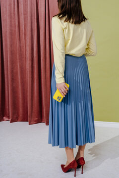 Businesswoman Standing with Smartphone Facing Away Indoors