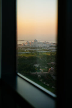 Sheikh Zayed Grand Mosque view through window at sunset