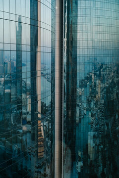 Glass skyscrapers reflecting Abu Dhabi coastline and city