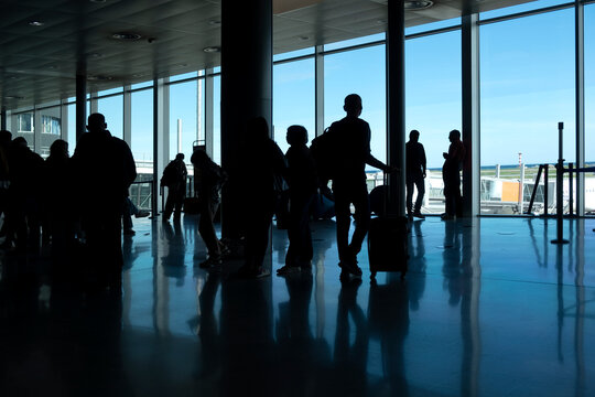 Silhouettes of people at the airport with copyspace