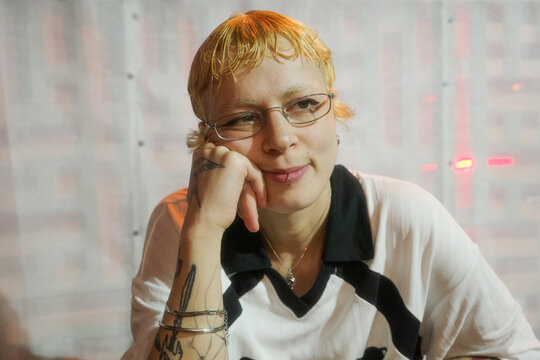 Person Sitting With Hand on Cheek in Casual Setting