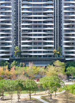 Modern High Rise Apartment Tower with Urban Green Park