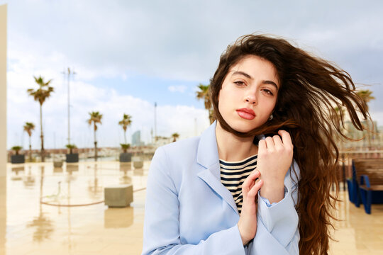 Woman Poses  in an Outdoor Space With Palm Trees