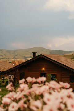 Wooden cabin with mountain hills beyond