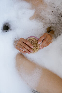 A close-up shot of a massage brush held in hands against a background 