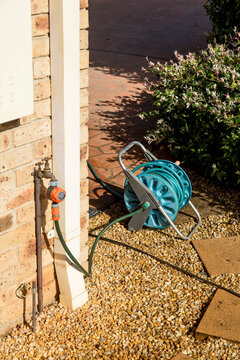 Garden hose reel beside house in rural New South Wales
