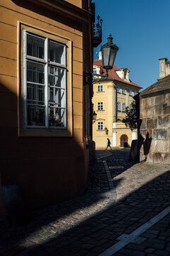 Sunlit Alley With Passing Figure
