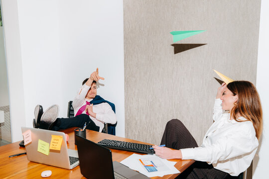 Team Members Have Fun With Paper Planes During a Break In the Office