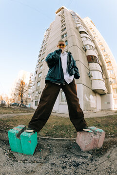 Person Standing on Blocks Near a Tall Building in City During Daytime