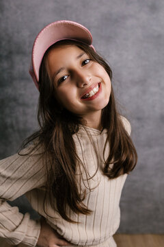 Happy girl smiling wearing pink cap portrait
