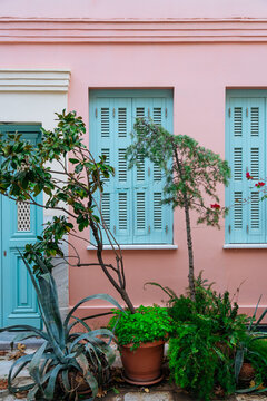 Pink Wall with Blue Shutters and Potted Plants