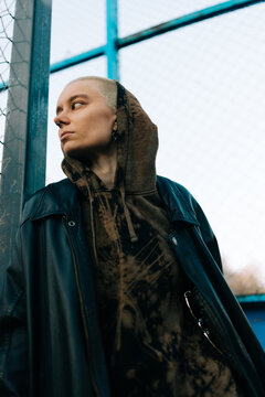 Person Wearing a Black Jacket and Hoodie in an Urban Area