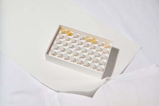 Organized Vials in White Box