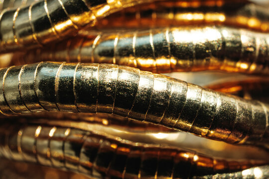 Gold Rings Stacked in an Artistic Design on a Light Background