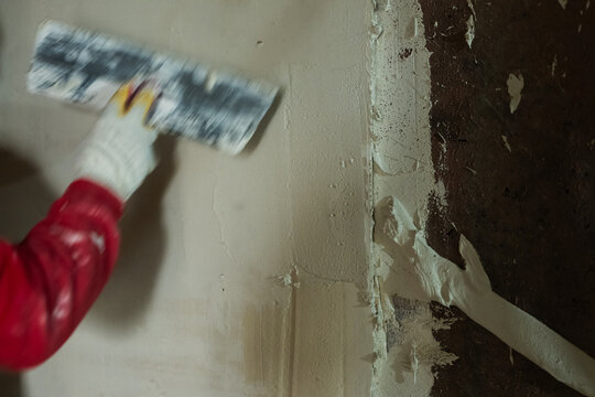 Applying plaster on wall