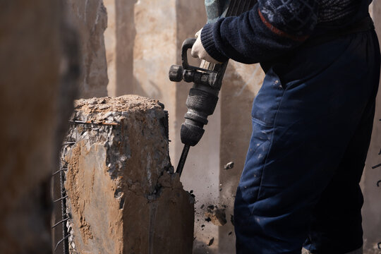 Breaking concrete with jackhammer