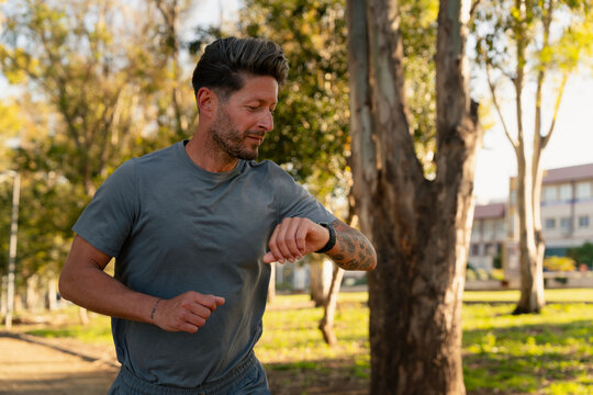 Runner Checking Watch Outdoors