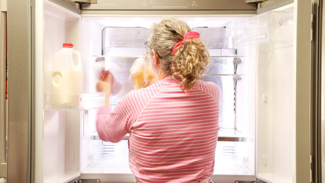 Woman Cleaning Refrigerator