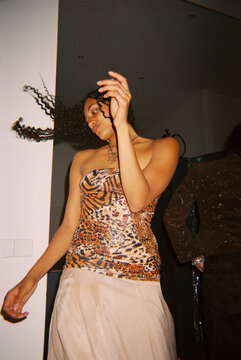 Woman dancing alone indoors at birthday party