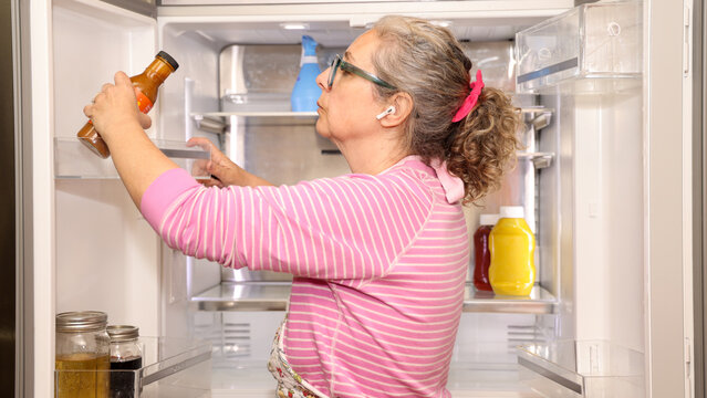 Woman Cleaning Refrigerator