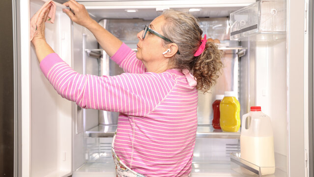 Woman Cleaning Refrigerator