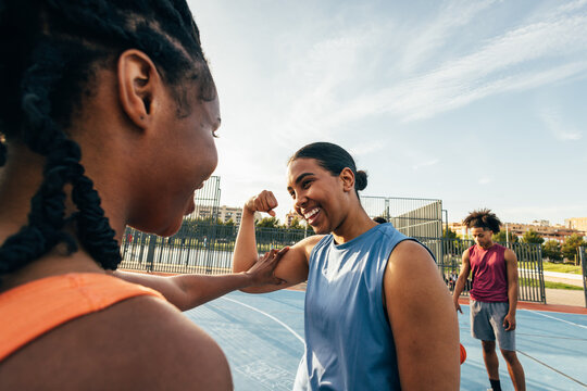 Friends enjoying a basketball game on a sunny day