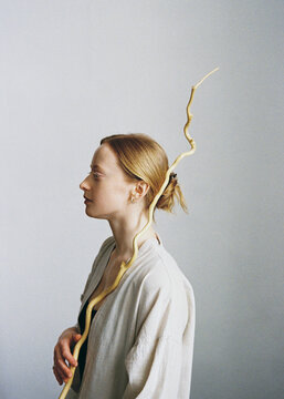 Young woman posing with a stick