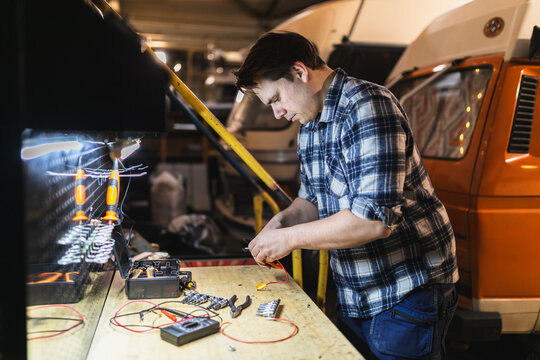 Professional Mechanic Repairing Electrical Components 