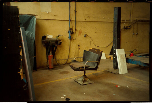Worn chair in industrial workshop