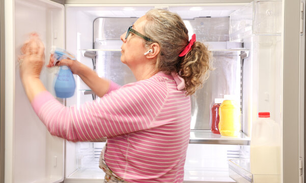 Woman Cleaning Refrigerator