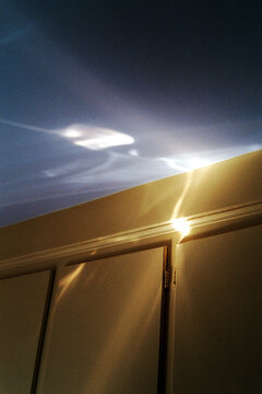 Golden light reflection on cabinet surface