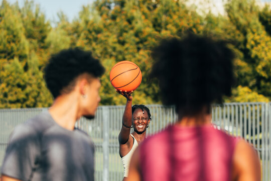 Energetic outdoor basketball game among friends